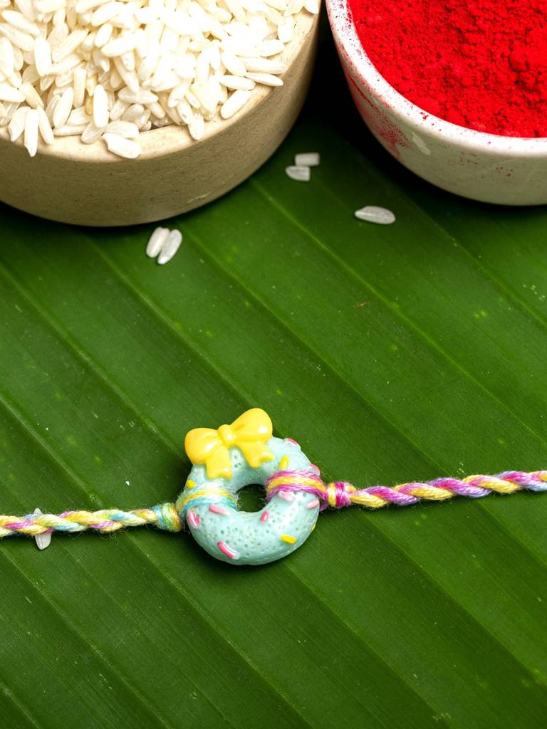 Eternz Certified Jewellery - Look and Adorn Acrylic Mint Green Doughnut Rakhi With Pastel Multicolor Dori Roli Chawal For Boys & Kids