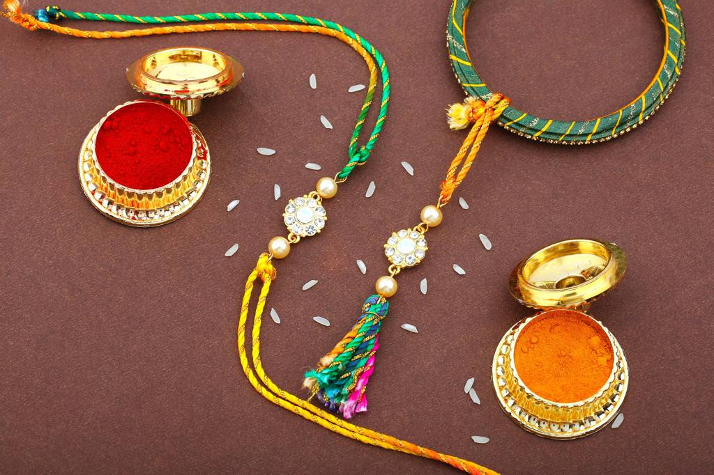 lated Floral Designer Bhaiya Bhabhi Rakhi Set With White Austrian Crystals And Pearls With Silk Multi-Color Thread : 209-IGRAKHI