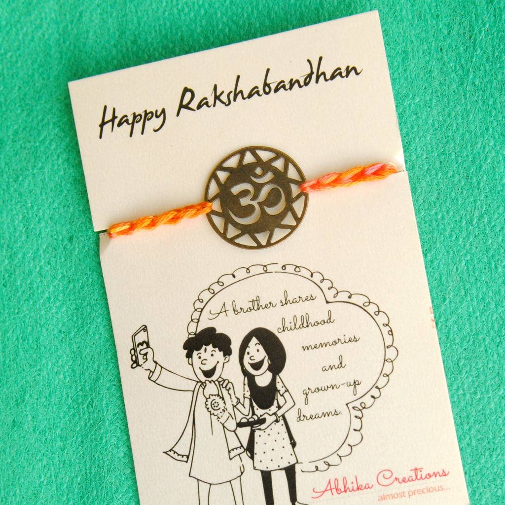 Om Quirky Rakhi With Roli Chawal Capsules : ACQR012-B