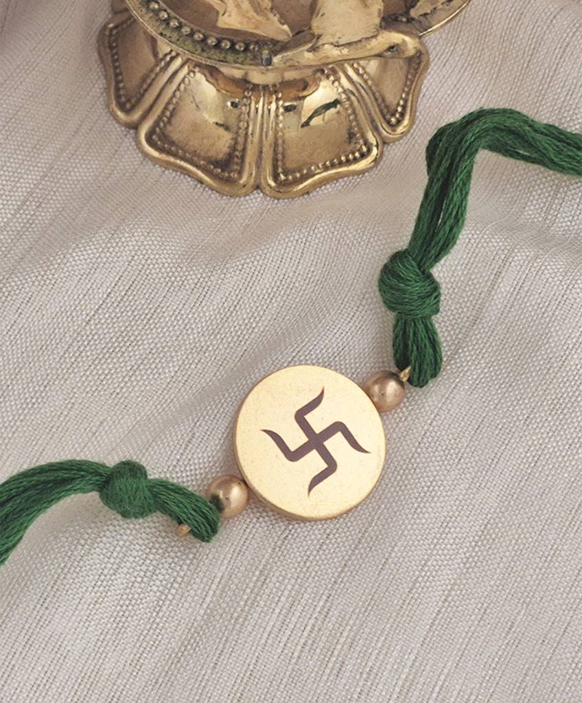 Gold Plated Swastik Rakhi With Emerald Green Thread : S9149