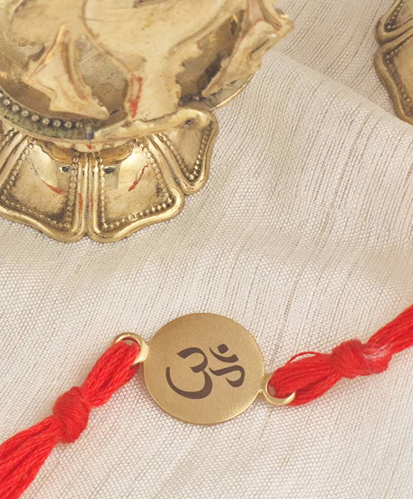Gold Plated Om Rakhi With Red Thread : S9160