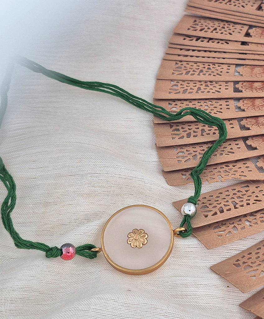 Gold Plated Acrylic Rakhi With Green Thread To Pendant : S9189