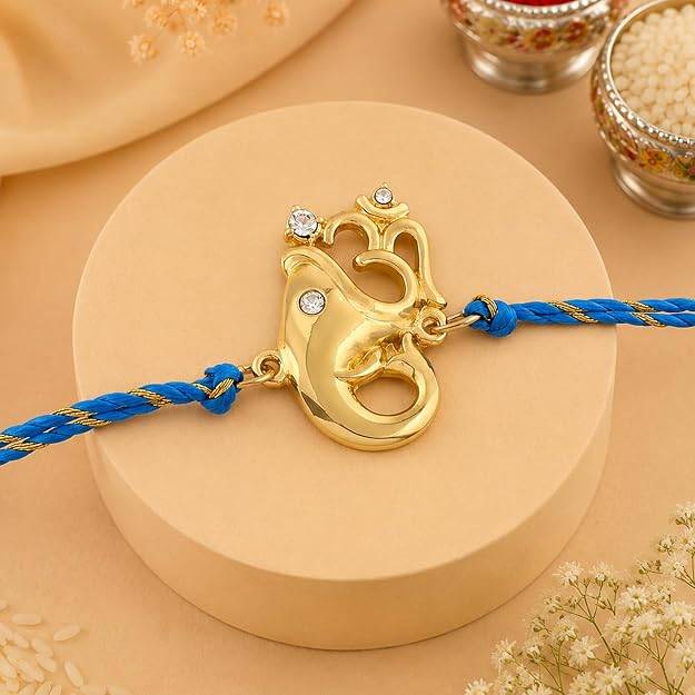 Eternz Certified Jewellery - Estele Gold Plated Blessed Ganesh Rakhi With Austrian Crystals And Fancy Silk Thread