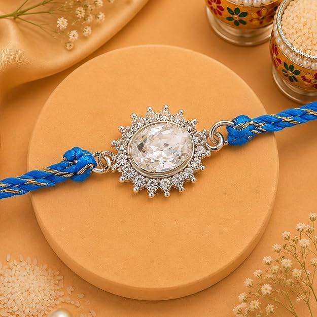 Eternz Certified Jewellery - Estele Rhodium Plated Sacred Sparkle Rakhi With Bold Austrian Crystals And Blessed Blue Silk Thread