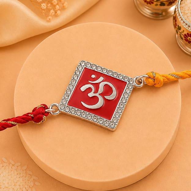 Eternz Certified Jewellery - Estele Rhodium Plated Divine Red Om Rakhi With Enamel & Austrian Crystals With Multi Colored Silk Thread