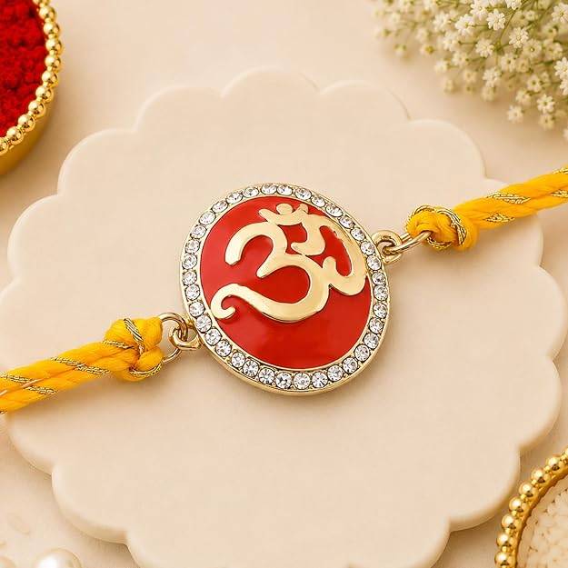 Gold Plated Eternal Om Rakhi With Red Enamel And Austrian Crystals & Fancy Silk Thread : 172-IG-RAKHI