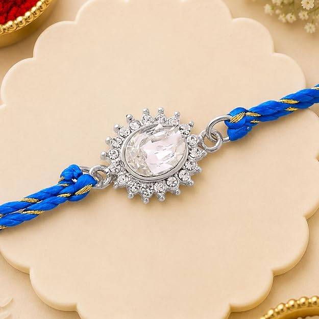 Rhodium Plated Sacred Sparkle Rakhi With Bold Austrian Crystals And Blessed Blue Silk Thread : 146-IG-RAKHI