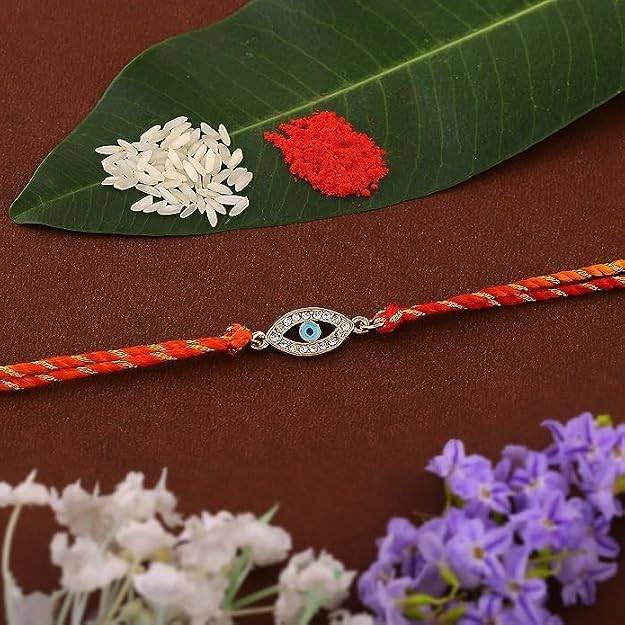 Gold Plated Auspicious Evil Eye Rakhi With Austrian Crystals And Multi Colored Silk Thread : 134-IG-RAKHI
