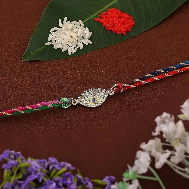 Gold Plated Sacred Evil Eye Rakhi With Austrian Crystals & Enamel And Multi Colored Silk Thread : 132-IG-RAKHI