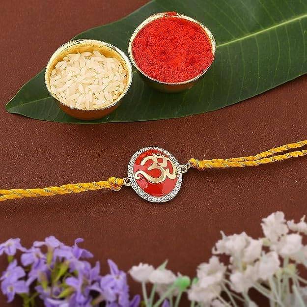 Gold Plated Eternal Om Rakhi With Red Enamel And Austrian Crystals & Fancy Silk Thread : 172-IG-RAKHI