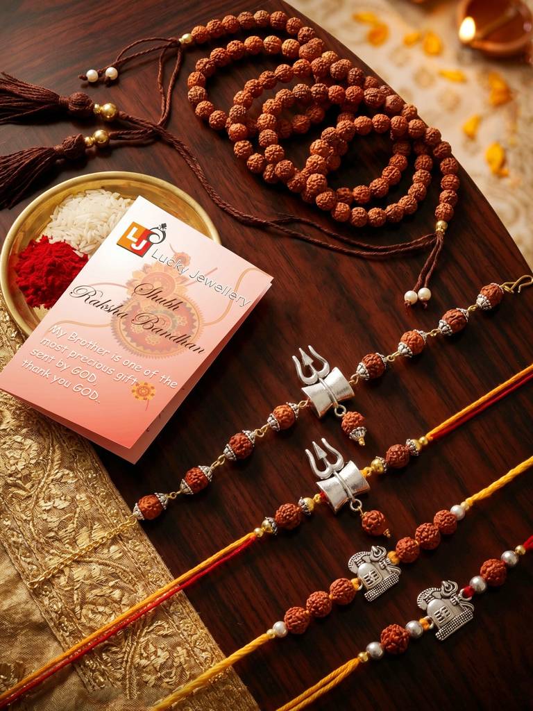 Set Of 5 Rudraksha & Silver Trishul Rakhi Set: Shiva-Themed, Metallic Accents, Roli, Chawal & Card (718 : 718-JPR1-1994-5-2026