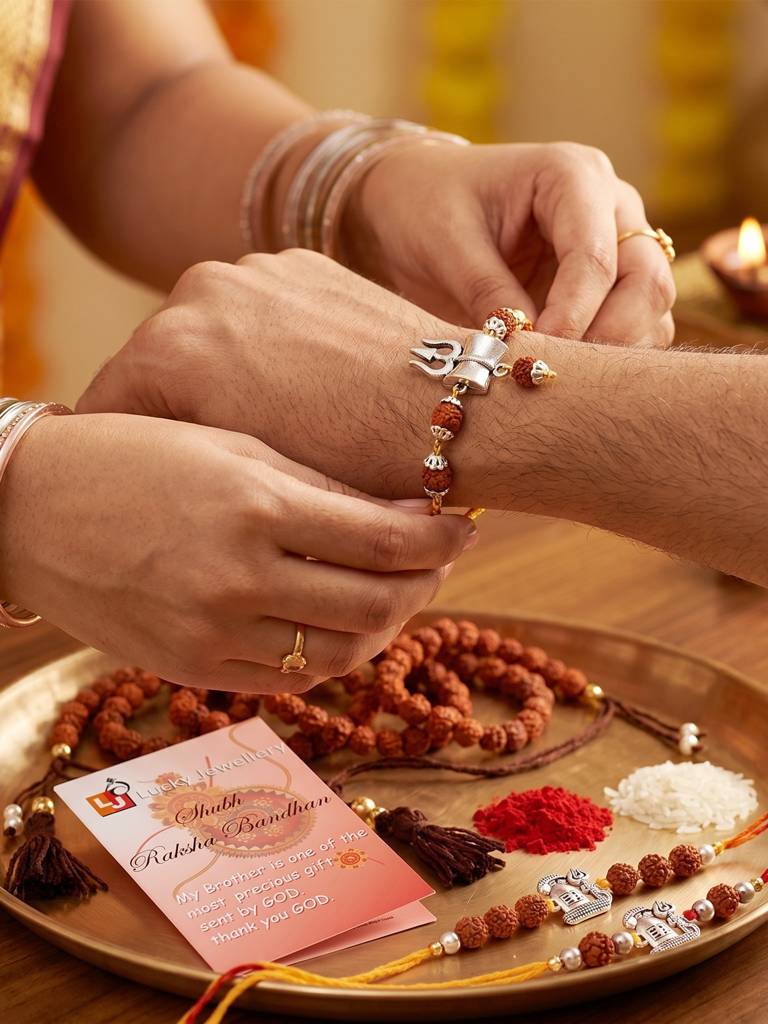 Set Of 5 Rudraksha & Silver Trishul Rakhi Set: Shiva-Themed, Metallic Accents, Roli, Chawal & Card (718 : 718-JPR1-1994-5-2026