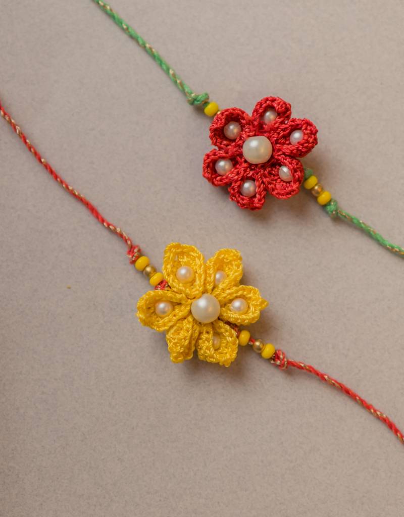 Eternz Certified Jewellery - SAMOOLAMRed And Yellow Crochet Rakhi (Set Of 2) with Sweets, Roli and Chawal